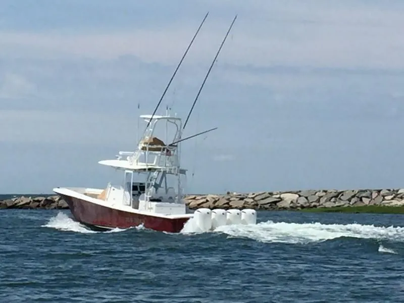Slide: The Image of 2016 Regulator 41 boat cruising on the water with fishing rods. - 3
