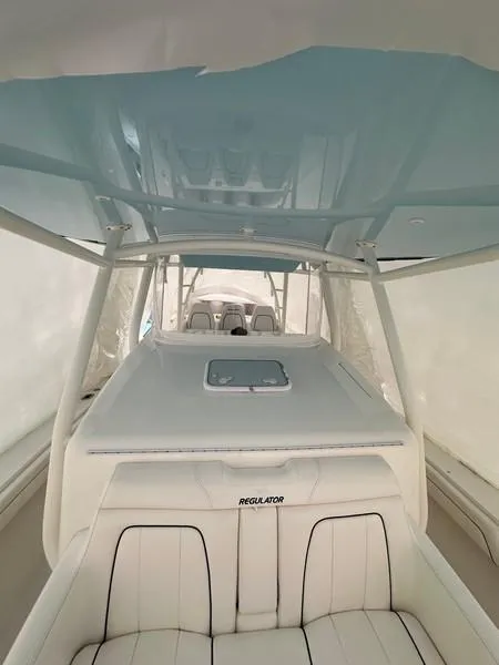 Slide: The Image of 2016 Regulator 41 boat interior with white seating and blue canopy. - 30