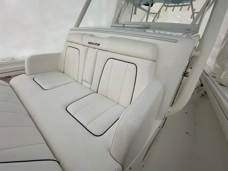Slide: The Image of White seating area on a 2016 Regulator 41 boat, featuring cushioned seats. - 31
