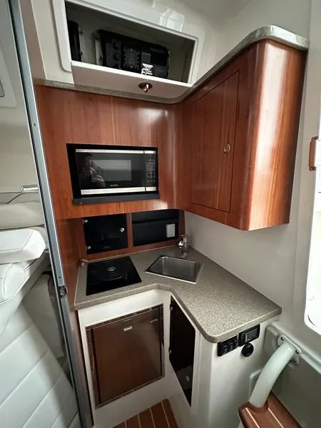 Slide: The Image of 2016 Regulator 41 boat interior kitchen with wood cabinetry and modern appliances. - 36