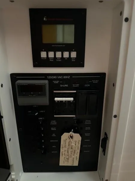 Slide: The Image of Electrical panel of a 2016 Regulator 41 boat with control switches and display. - 39