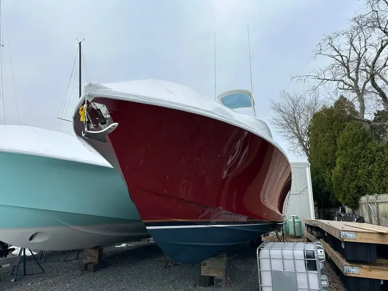 Slide: The Image of 2016 Regulator 41 boat with red hull, stored on land, side view. - 4