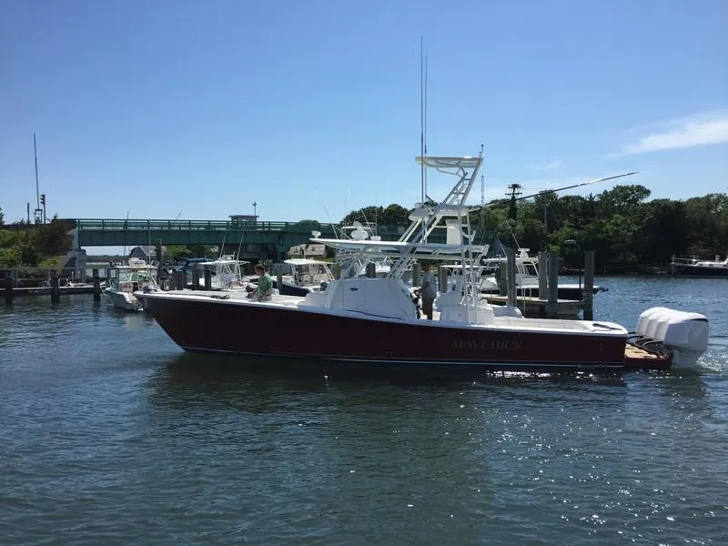 Slide: The Image of 2016 Regulator 41 boat docked in a marina under clear blue sky. - 42