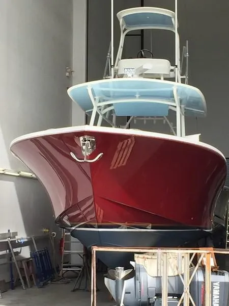 Slide: The Image of 2016 Regulator 41 boat with red hull in storage facility. - 43