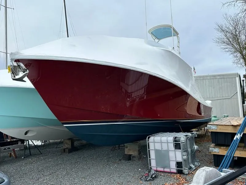 Slide: The Image of 2016 Regulator 41 boat with red hull, stored on land. - 5