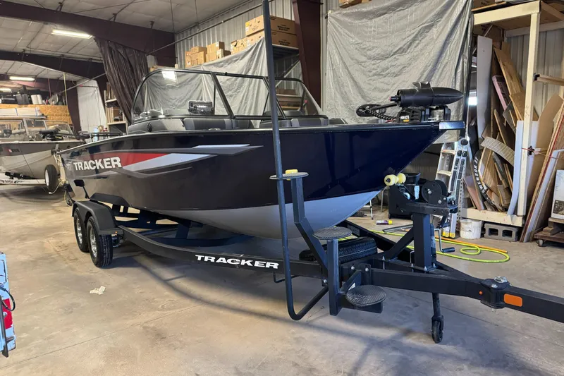 The Image of 2025 Tracker TARGA V18WT boat in a garage, on a trailer, ready for transport. - 1