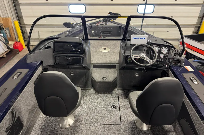 Slide: The Image of 2025 Tracker TARGA V18WT boat interior with dual seats and steering console. - 6
