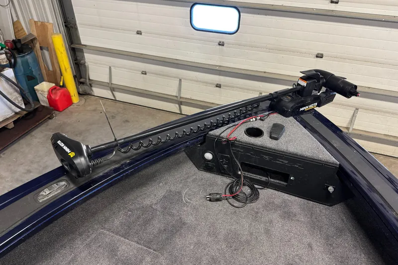 Slide: The Image of 2025 Tracker TARGA V18WT boat with trolling motor in a garage setting. - 10