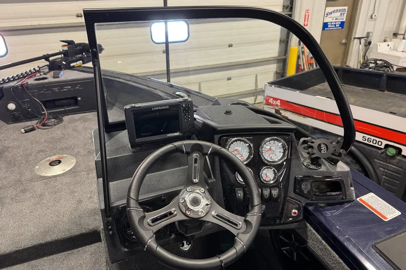 Slide: The Image of 2025 Tracker TARGA V18WT boat dashboard with steering wheel and gauges. - 11