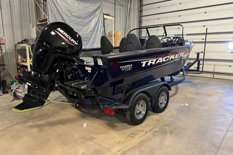 Slide: The Image of 2025 Tracker TARGA V18WT boat with Mercury engine in a garage. - 4