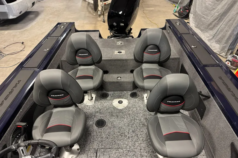 Slide: The Image of 2025 Tracker TARGA V18WT boat interior with four gray seats and carpeted flooring. - 8