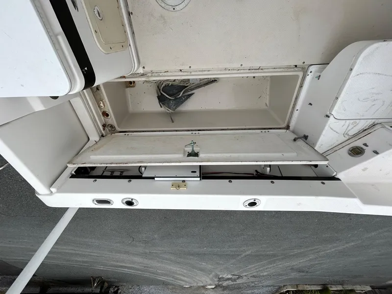 Slide: The Image of 1996 Robalo 2440 Walkaround boat storage compartment with anchor inside. - 11