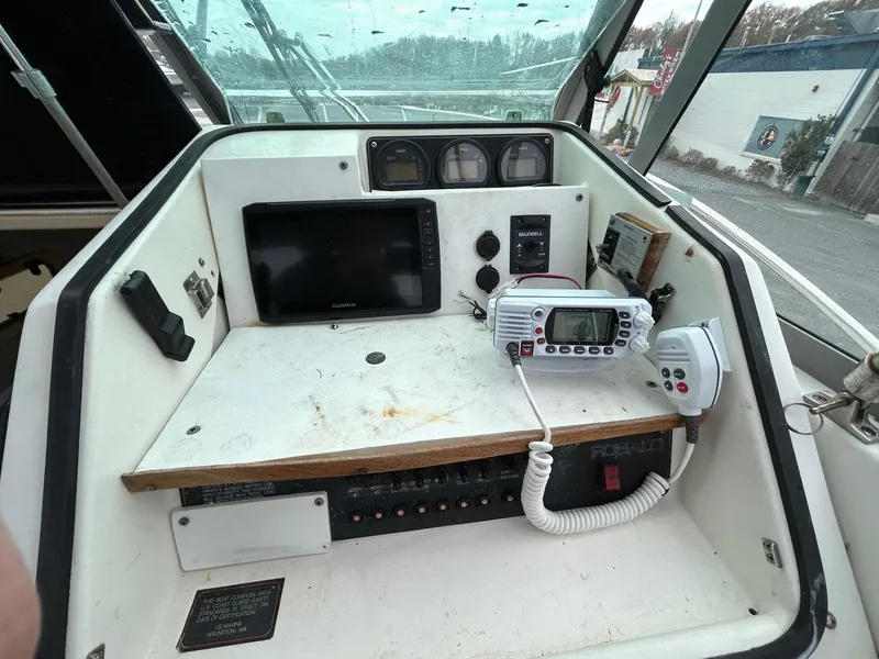 Slide: The Image of 1996 Robalo 2440 Walkaround boat dashboard with navigation equipment and controls. - 15