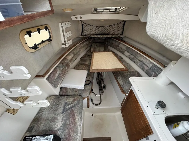 Slide: The Image of Interior of 1996 Robalo 2440 Walkaround boat with seating and table. - 17