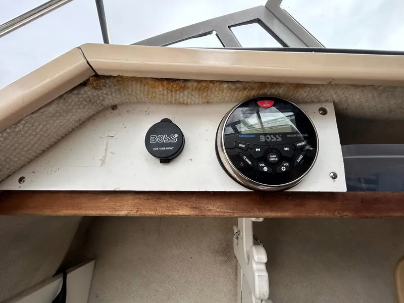 Slide: The Image of 1996 Robalo 2440 Walkaround boat dashboard with Boss audio system. - 19