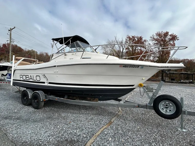 Slide: The Image of 1996 Robalo 2440 Walkaround boat on trailer, outdoor setting. - 3