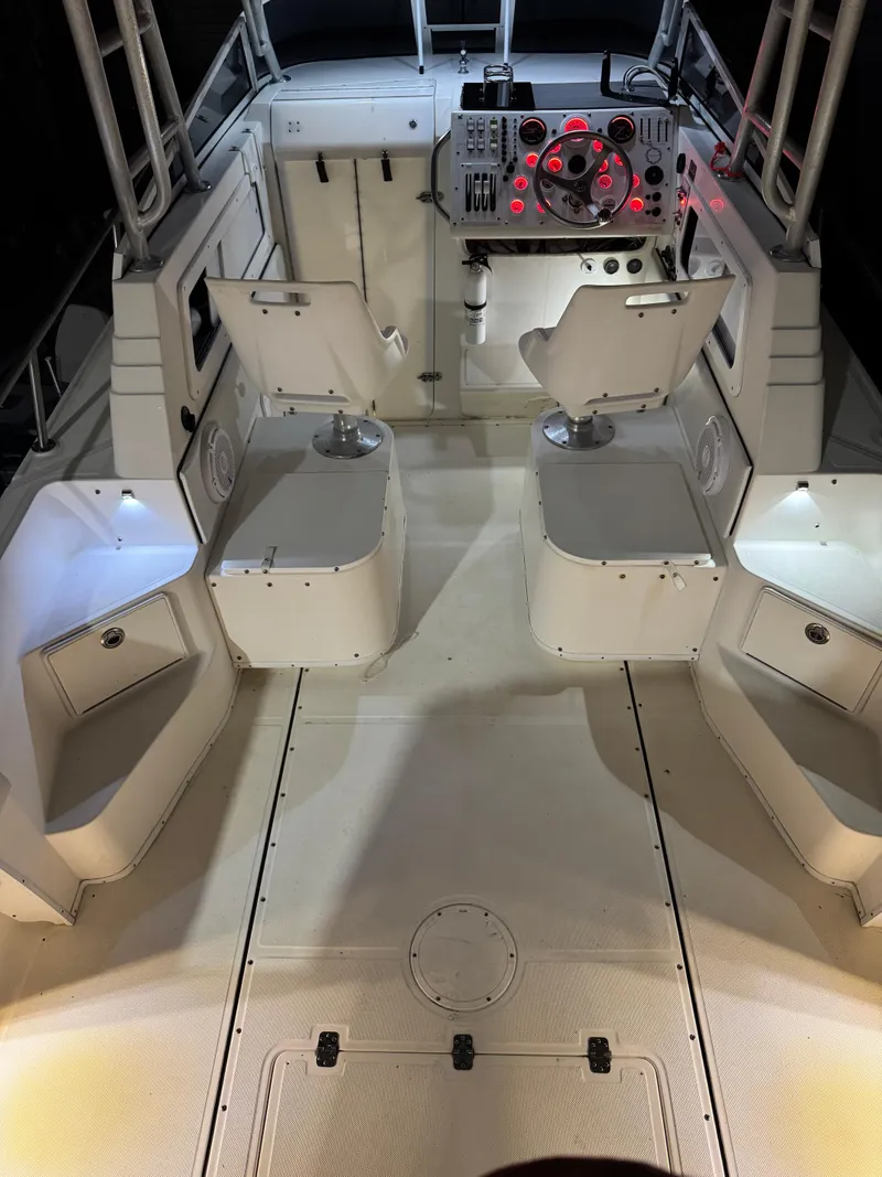 Slide: The Image of 1996 Fountain 32 Sportfish Cruiser IO interior with illuminated cockpit and seating. - 10