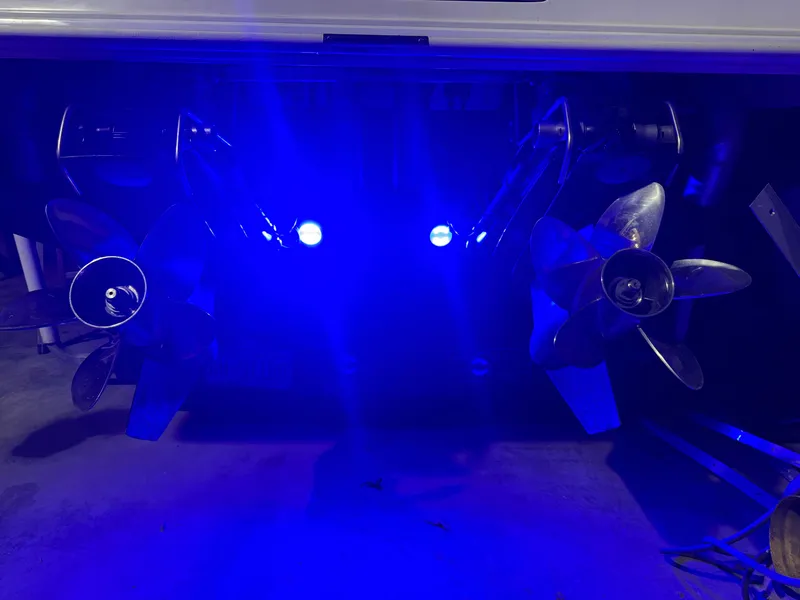 Slide: The Image of 1996 Fountain 32 Sportfish Cruiser IO with illuminated propellers in blue light. - 13