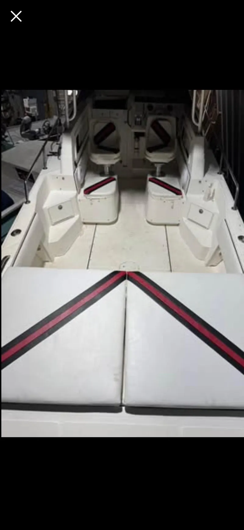 Slide: The Image of 1996 Fountain 32 Sportfish Cruiser IO interior with seating and storage compartments. - 14
