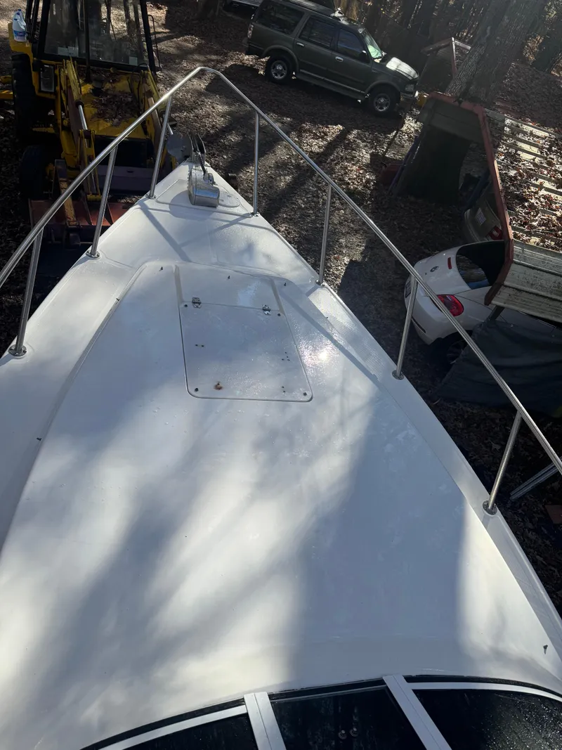 Slide: The Image of 1996 Fountain 32 Sportfish Cruiser IO boat deck in outdoor setting. - 4