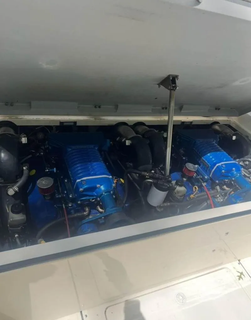 Slide: The Image of 1996 Fountain 32 Sportfish Cruiser IO engine compartment with dual blue engines. - 5