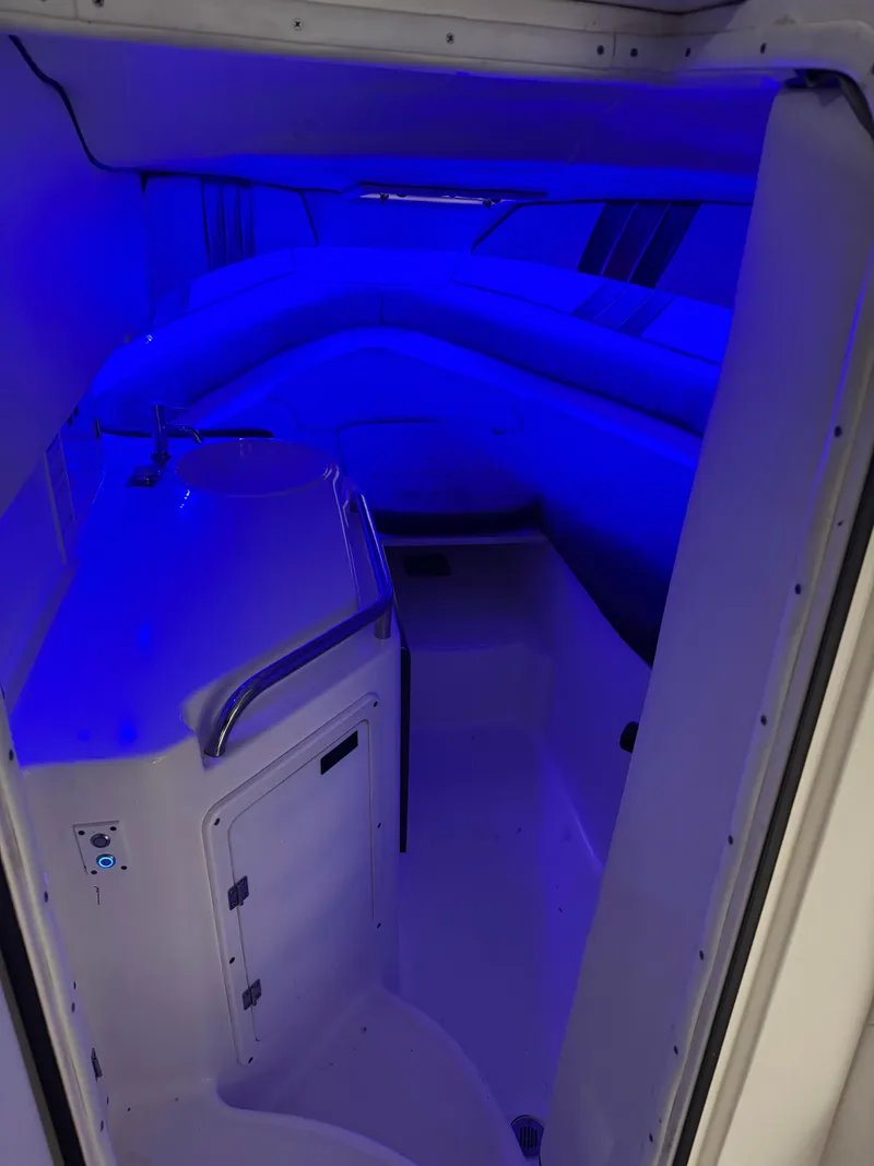 Slide: The Image of 1996 Fountain 32 Sportfish Cruiser IO cabin with blue ambient lighting. - 6