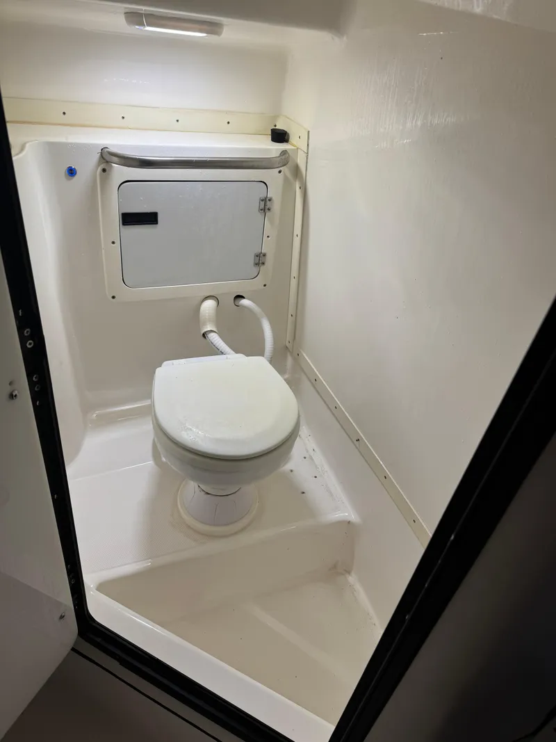 Slide: The Image of 1996 Fountain 32 Sportfish Cruiser IO boat bathroom interior with toilet. - 7