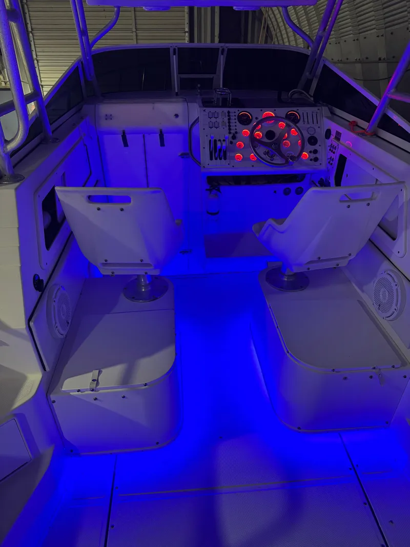 Slide: The Image of 1996 Fountain 32 Sportfish Cruiser IO cockpit with blue LED lighting. - 9