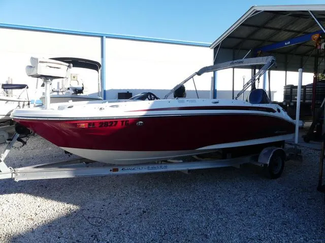 Slide: The Image of 2022 Hurricane SunDeck Sport 185 OB boat on trailer in storage facility. - 10