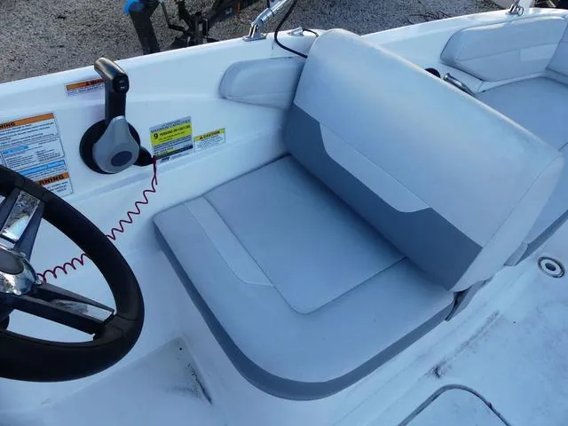 Slide: The Image of 2022 Hurricane SunDeck Sport 185 OB boat interior with steering wheel and seating. - 16