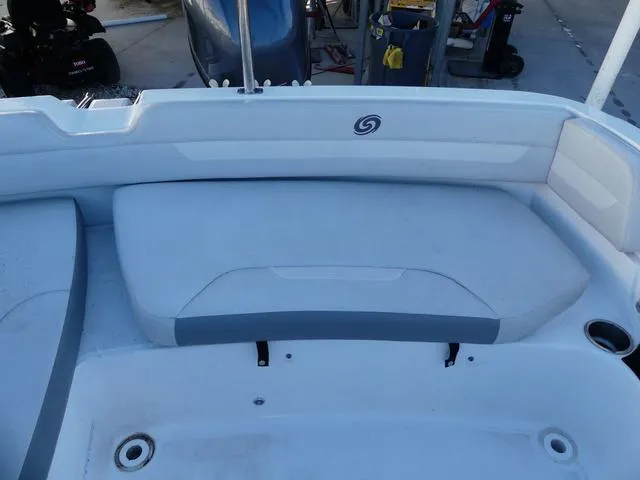 Slide: The Image of 2022 Hurricane SunDeck Sport 185 OB boat interior with cushioned seating and cup holder. - 18