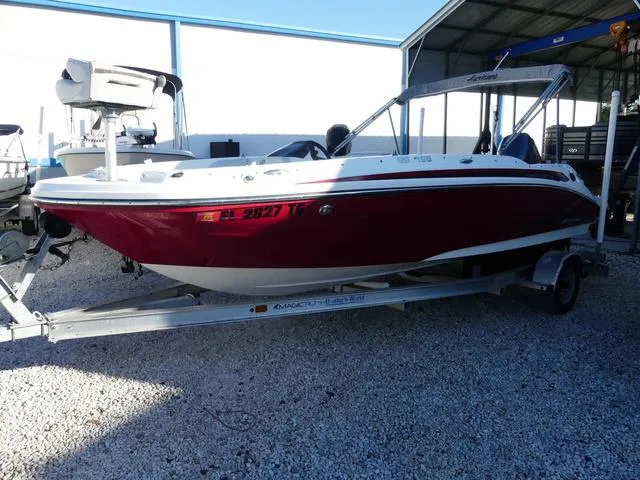 Slide: The Image of 2022 Hurricane SunDeck Sport 185 OB boat on trailer, red and white exterior. - 3