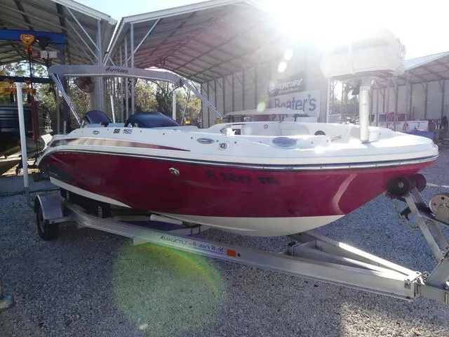 Slide: The Image of 2022 Hurricane SunDeck Sport 185 OB boat on trailer in storage facility. - 5