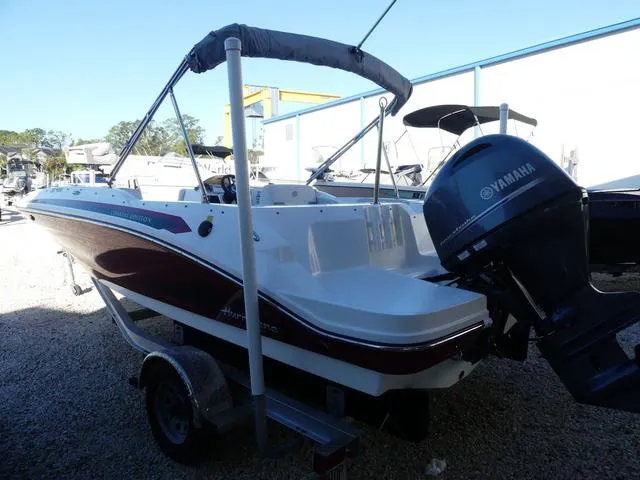 Slide: The Image of 2022 Hurricane SunDeck Sport 185 OB boat with Yamaha outboard motor, parked on gravel. - 9