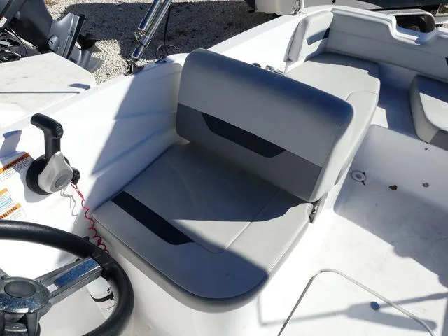 Slide: The Image of 2021 Hurricane SunDeck Sport 185 OB boat interior with gray seating and steering wheel. - 12