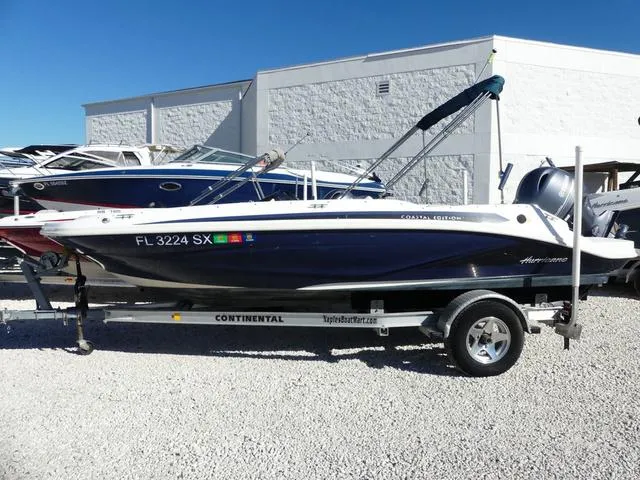 Slide: The Image of 2021 Hurricane SunDeck Sport 185 OB boat on trailer, parked outdoors. - 4