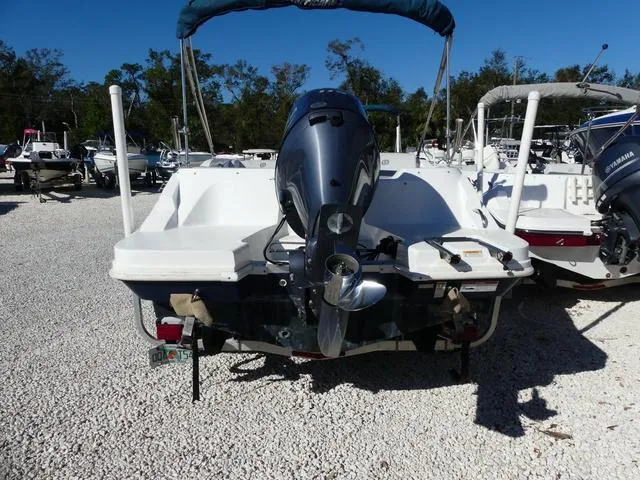 Slide: The Image of 2021 Hurricane SunDeck Sport 185 OB boat with outboard motor in a gravel lot. - 6