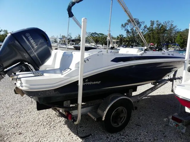 Slide: The Image of 2021 Hurricane SunDeck Sport 185 OB boat on trailer, featuring Yamaha outboard motor. - 8