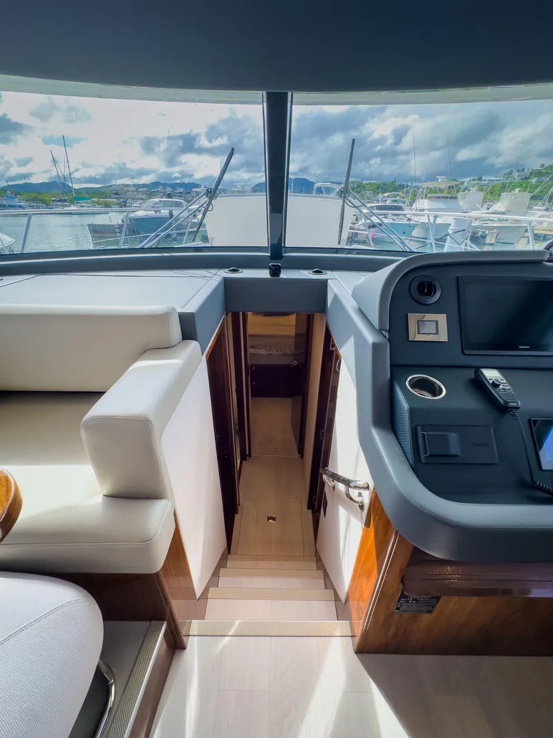Slide: The Image of Interior view of 2024 Riviera 465 SUV yacht, featuring modern helm and seating area. - 11