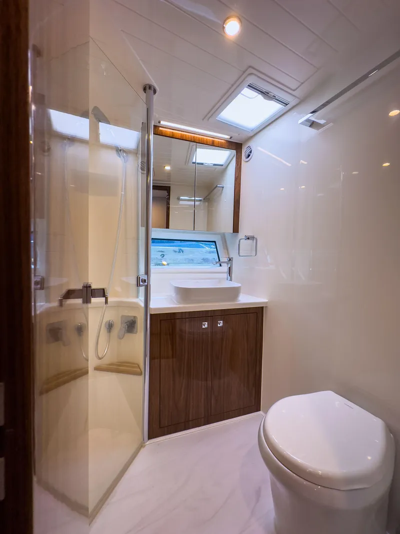Slide: The Image of Luxurious bathroom in 2024 Riviera 465 SUV yacht with modern fixtures and elegant design. - 12