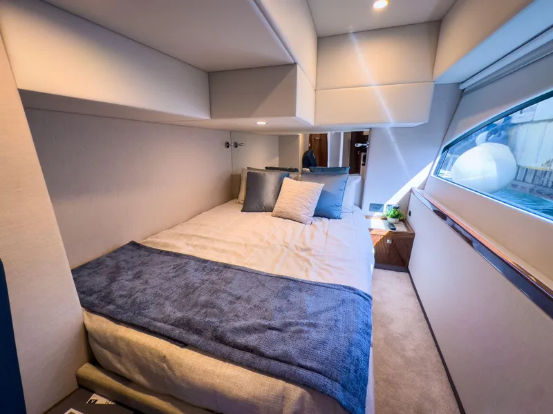 Slide: The Image of Luxurious bedroom interior of 2024 Riviera 465 SUV yacht with modern design and cozy bedding. - 13