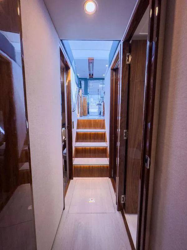 Slide: The Image of 2024 Riviera 465 SUV interior hallway with modern design and wooden accents. - 17
