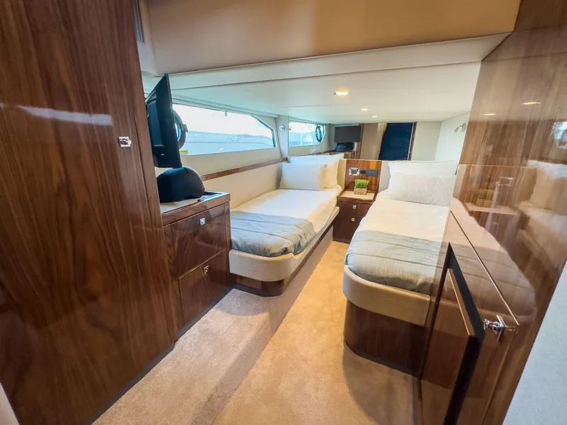 Slide: The Image of 2024 Riviera 465 SUV interior with twin beds and wooden cabinetry. - 4
