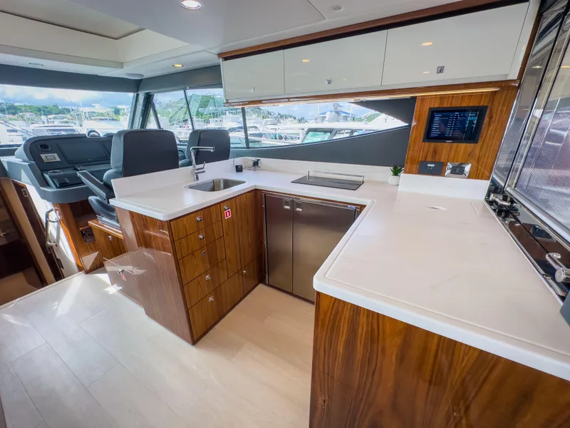 Slide: The Image of Luxurious interior of 2024 Riviera 465 SUV yacht with modern kitchen design. - 5