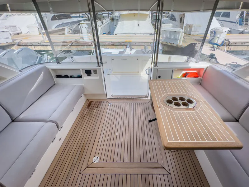 Slide: The Image of 2024 Riviera 465 SUV yacht interior with seating and wooden table. - 6