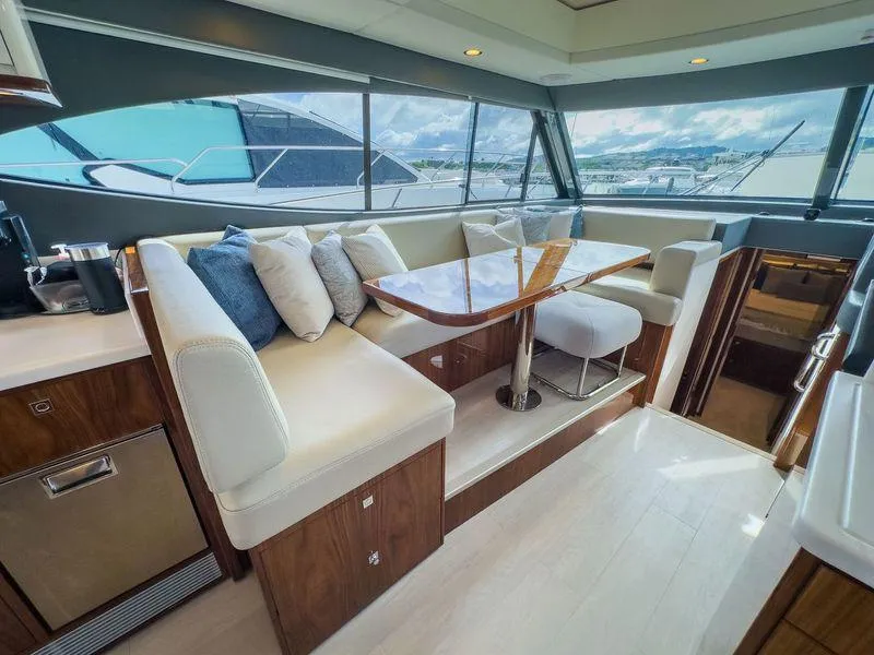 Slide: The Image of Luxurious interior of 2024 Riviera 465 SUV yacht with elegant seating and panoramic windows. - 8