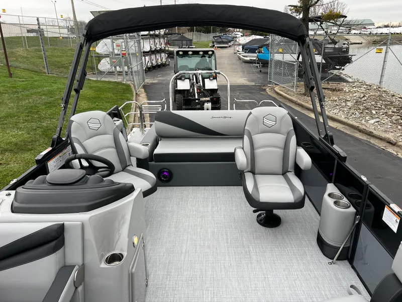Slide: The Image of 2025 South Bay S222 UL pontoon boat interior with seating and steering console. - 11