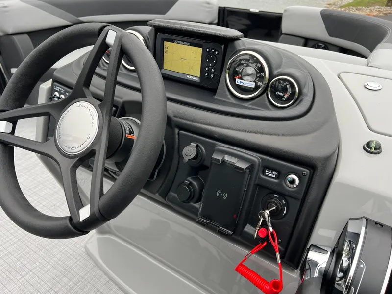 Slide: The Image of 2025 South Bay S222 UL boat dashboard with steering wheel and navigation controls. - 22