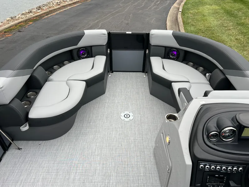 Slide: The Image of 2025 South Bay S222 UL pontoon boat interior with gray seating and modern dashboard. - 24