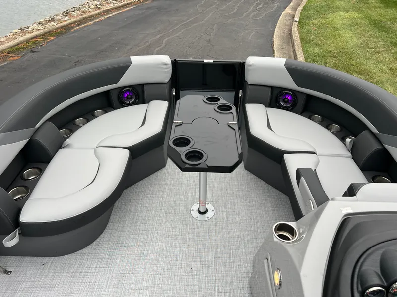 Slide: The Image of 2025 South Bay S222 UL pontoon boat interior with gray seating and cup holders. - 25